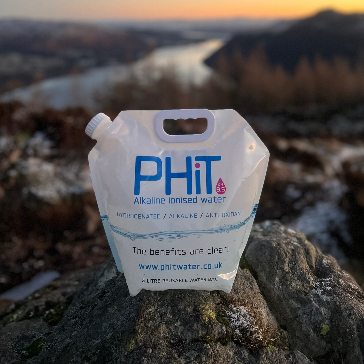 PHIT water pouch on a rock with a scenic background