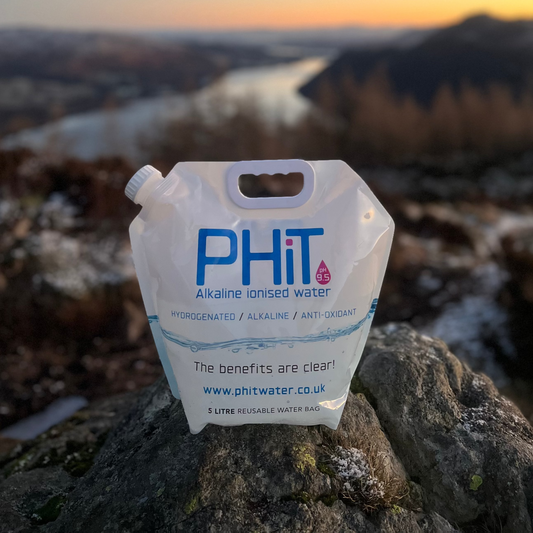 PHIT water pouch on a rock with a scenic background
